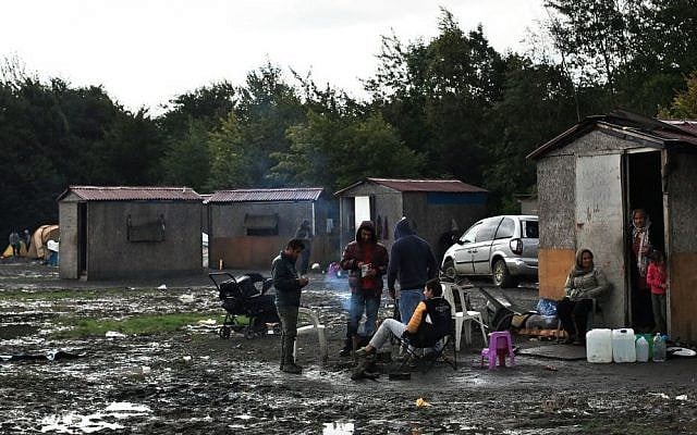 In this photo taken September 18, 2015, migrants from Syria wait in the migrant camp of Grande Synthe, before an attempt to get to Britain, outside Dunkirk, northern France. (AP/Thibault Camus) 