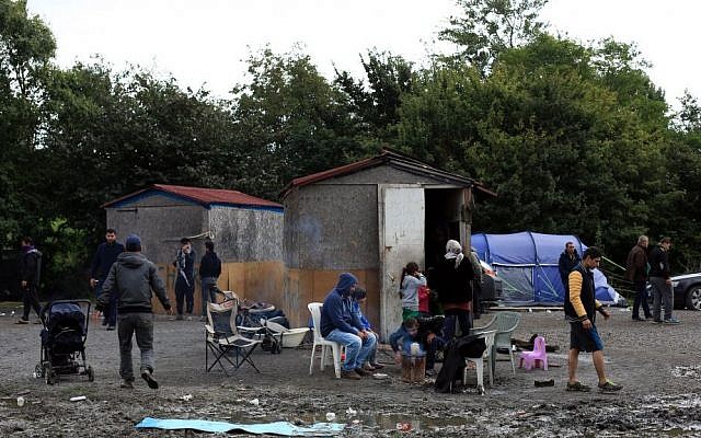 In this September 18, 2015 photo, migrants from Syria wait in the migrant camp of Grande Synthe, before an attempt to get to Britain, outside Dunkirk, northern France. (AP/Thibault Camus)