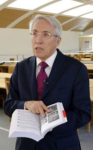 Frederic de Laurens, a former top manager at French national archives, holds a book on Goering's looted art, Wednesday, September 30, 2015 outside Paris, France. (AP Photo/Jacques Brinon)