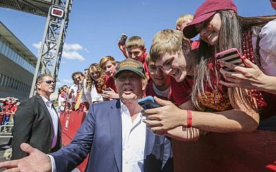 Republican presidential candidate Donald Trump poses for a photo with Iowa State fans before an NCAA college football game between Iowa State and Iowa, Saturday, Sept. 12, 2015, in Ames, Iowa. (Rodney White/The Des Moines Register via AP) 