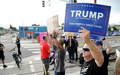 Supporters of Republican presidential candidate Donald Trump and demonstrators who are protesting against Trump's campaign appearance aboard the USS Iowa battleship meet across the street from the event site in Los Angeles, Tuesday, Sept. 15, 2015. (AP Photo/Kevork Djansezian)