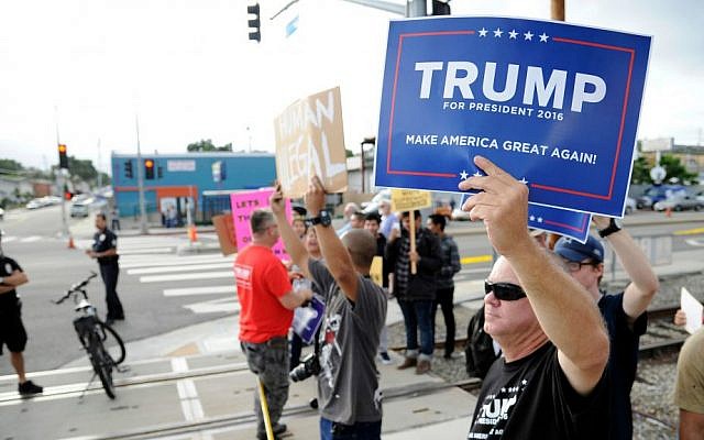 Supporters of Republican presidential candidate Donald Trump and demonstrators who are protesting against Trump's campaign appearance aboard the USS Iowa battleship meet across the street from the event site in Los Angeles, Tuesday, Sept. 15, 2015. (AP Photo/Kevork Djansezian)