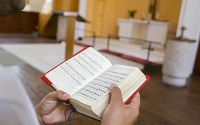 An Iranian asylum-seeker sings Christian songs in the Trinity Church in Berlin, Germany, Aug. 13, 2015. (AP/Gero Breloer)
