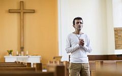 Iranian asylum-seeker Aref Movasaq Rodsari stands in the Trinity Church in Berlin, Germany, Aug. 13, 2015. (AP/Gero Breloer)