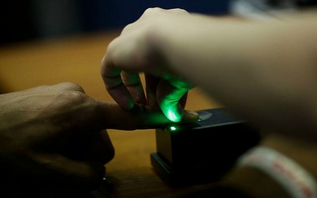 A police officer takes the fingerprint of a man during his registration at the temporary registration center for migrants and refugees of the southern German border town Passau, Tuesday, Sept. 15, 2015. (AP Photo/Markus Schreiber) A police officer takes the fingerprint of a man during his registration at the temporary registration center for migrants and refugees of the southern German border town Passau, Tuesday, Sept. 15, 2015. (AP Photo/Markus Schreiber)