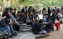 Illustrative photo of refugees waiting for registration outside the state office for health and social issues in Berlin, Germany, on September 25 2015. (Bernd von Jutrczenka/dpa via AP)
