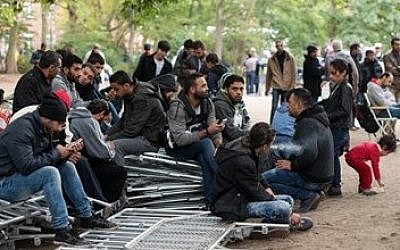 Illustrative photo of refugees waiting for registration outside the state office for health and social issues in Berlin, Germany, on September 25 2015. (Bernd von Jutrczenka/dpa via AP)