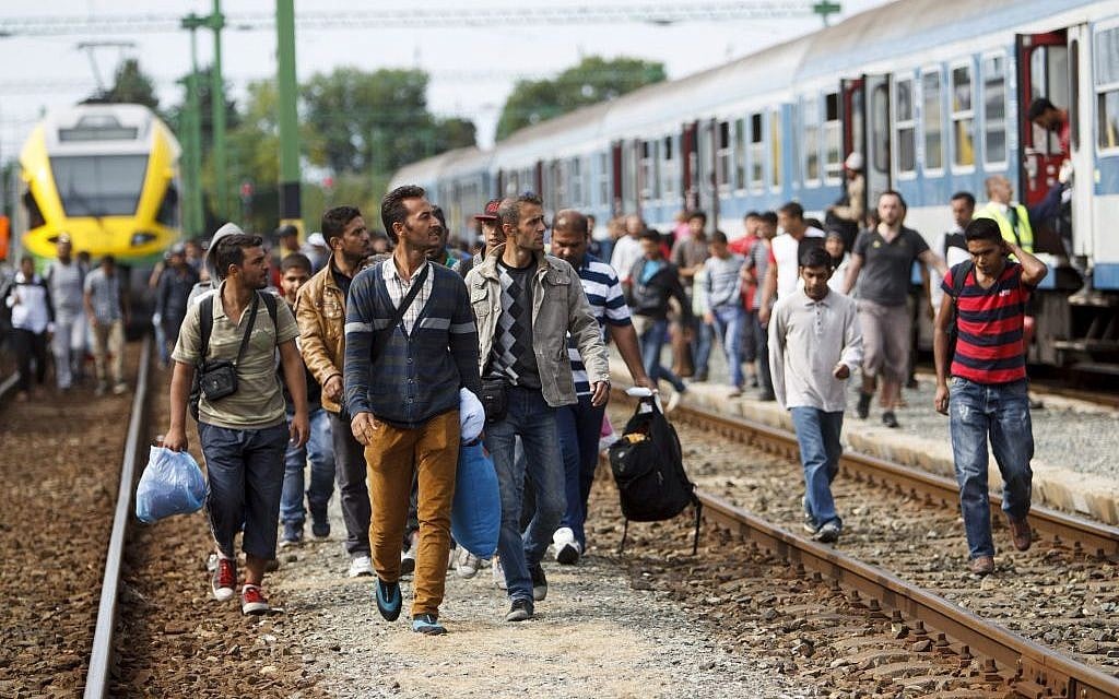 Migrants and refugees arrive at the railway station in Szentgotthard, 246 kilometers southwest of Budapest, Hungary, near the Austrian border, Sept. 19, 2015. (Gyorgy Varga/MTI via AP)