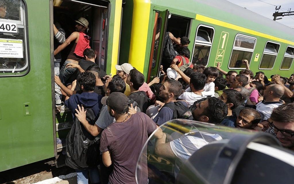 Migrants get back on a train in Bicske, Hungary, Thursday, Sept. 3, 2015. (AP/Petr David Josek)