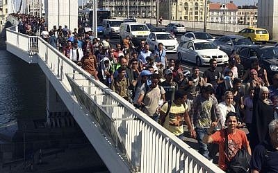 A large group of asylum seekers walk out of Budapest, Hungary, Sept. 4, 2015. (AP/Frank Augstein)