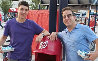 Jewish educator Yoni Kaiser-Blueth, right, with incoming George Washington University freshman Yonah Bromberg Gaber at a recent Washington Nationals game, said that Sandy Koufax’s Yom Kippur decision 'resonates especially today.' (Hillel Kuttler/JTA)