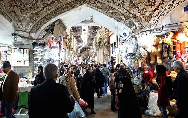 Illustrative: Iranians walking through Tehran’s old main bazaar, March 18, 2014. (JTA/Ebrahim Noroozi/AP Images)