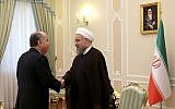 In this photo released by the official website of the office of the Iranian Presidency on Sunday, Sept. 13, 2015, Iran's President Hassan Rouhani, right, greets Brazilian Foreign Minister Mauro Luiz Iecker Vieira at the start of their meeting in Tehran, Iran. (Iranian Presidency Office via AP)