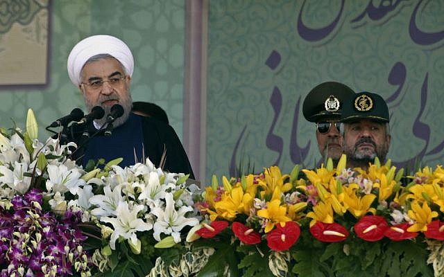 Iranian President Hassan Rouhani, left, speaks at a military parade marking the 35th anniversary of Iraq's 1980 invasion of Iran, attended by Revolutionary Guard commander Mohammad Ali Jafari, right,in front of the shrine of the late revolutionary founder, Ayatollah Khomeini, just outside Tehran, Iran, Tuesday, Sept. 22, 2015. (AP Photo/Vahid Salemi) Iranian President Hassan Rouhani, left, speaks at a military parade marking the 35th anniversary of Iraq's 1980 invasion of Iran, attended by Revolutionary Guard commander Mohammad Ali Jafari, right,in front of the shrine of the late revolutionary founder, Ayatollah Khomeini, just outside Tehran, Iran, Tuesday, Sept. 22, 2015. (AP Photo/Vahid Salemi)