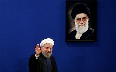 Iran's President Hassan Rouhani waves to reporters at the conclusion of a press conference in Tehran, Iran, August 29, 2015. (AP/Ebrahim Noroozi)