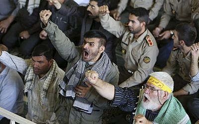 Iranian worshipers chant slogans such as "death to Al-Saud family," a reference to the rulers of the Saudi kingdom, in a reaction to the hajj crush deaths in mid-September 2015, while they listen to the sermons of the Friday prayer in Tehran, Iran, Friday, Sept. 25, 2015. (AP/Vahid Salemi)