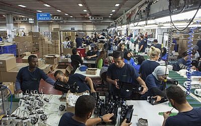 Employees work at the SodaStream factory built deep in Israel's Negev Desert next to the city of Rahat, Israel, September 2, 2015. (AP/Dan Balilty) Employees work at the SodaStream factory built deep in Israel's Negev Desert next to the city of Rahat, Israel, September 2, 2015. (AP/Dan Balilty)