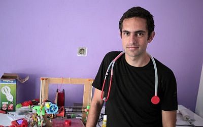 Dr. Tarek Loubani, a Palestinian-Canadian doctor, poses for a picture with 3D printed stethoscope around his neck, in Gaza City on September 7, 2014. (AP Photo/ Khalil Hamra)