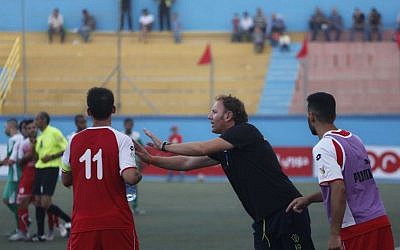 Italian Stefano Cusin, coach of the Palestinian Ahli Al-Khalil football club, advises a player during the "Super Cup" match against al-Dahria at the Faisal al-Husseini Stadium in the West Bank town of Al-Ram, north of Jerusalem on September 11, 2015. (AP/Nasser Shiyoukhi)