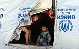 Illustrative: Syrian refugee children look from their tent during a visit by UN humanitarian chief Stephen O'Brien to the Zaatari Refugee Camp, near Mafraq, Jordan, September 19, 2015. (AP Photo/Raad Adayleh)