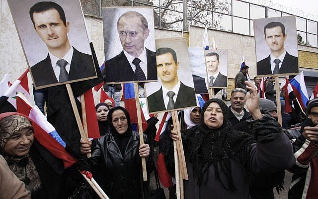 In this Sunday, March 4, 2012 file photo, Syrians hold posters of Syrian President Bashar Assad, far left, and Russian President Vladimir Putin, second left, during a pro-Syrian government protest in front of the Russian Embassy in Damascus, Syria. (AP/Muzaffar Salman, File) In this Sunday, March 4, 2012 file photo, Syrians hold posters of Syrian President Bashar Assad, far left, and Russian President Vladimir Putin, second left, during a pro-Syrian government protest in front of the Russian Embassy in Damascus, Syria. (AP/Muzaffar Salman, File)