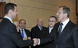 Syrian President Bashar Assad, left, shakes hands with Russian Foreign Minister Sergey Lavrov after talks in Damascus, Syria on February 7, 2012 (AP/Pool, File)