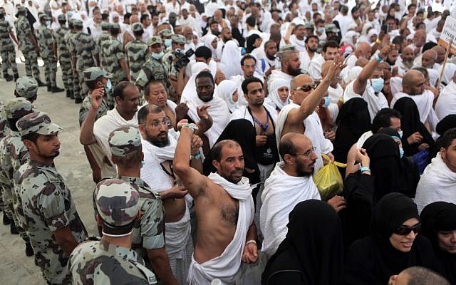 In this October 4, 2014 photo,soldiers look on as Muslim pilgrims cast stones at a pillar in a ritual called "Jamarat," symbolizing the stoning of Satan, the last rite of the annual hajj, in Mecca, Saudi Arabia. (AP/Khalid Mohammed) In this October 4, 2014 photo,soldiers look on as Muslim pilgrims cast stones at a pillar in a ritual called "Jamarat," symbolizing the stoning of Satan, the last rite of the annual hajj, in Mecca, Saudi Arabia. (AP/Khalid Mohammed)