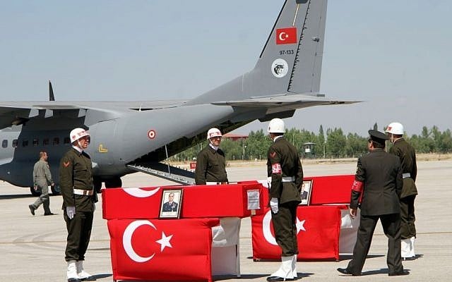 Turkish soldiers prepare the coffins of fallen comrades killed in a Kurdish rebel attack before a ceremony at the military airport in Van, Turkey, Sept. 8, 2015. (IHA Agency via AP) Turkish soldiers prepare the coffins of fallen comrades killed in a Kurdish rebel attack before a ceremony at the military airport in Van, Turkey, Sept. 8, 2015. (IHA Agency via AP)