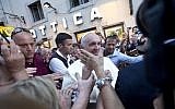 Pope Francis leaves an eyeglass store on Via del Babuino, in central Rome, Thursday, Sept. 3, 2015. Pope Francis slipped out of the Vatican Thursday for a personal errand: New glasses. (AP Photo/Alessandra Tarantino)