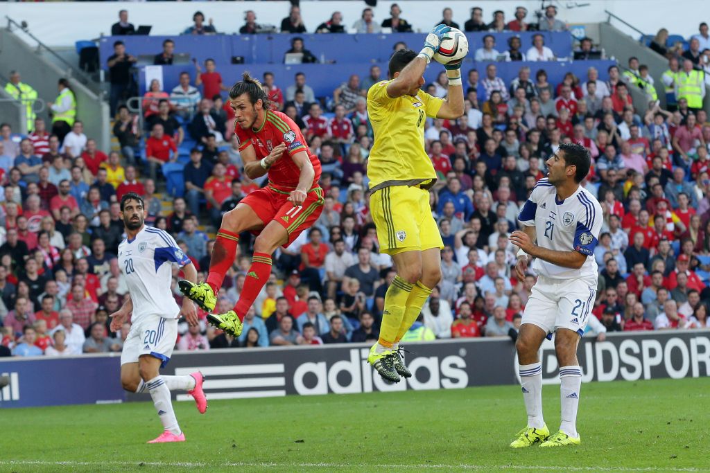 Wales’s Gareth Bale, center left, is beaten to the ball by Israel’s goalkeeper Ofir Marciano during the Euro 2016 Group B qualifying match between Israel and Wales at the Cardiff City stadium in Cardiff, Wales, Sunday, September 6, 2015. (Tim Ireland/AP) Wales’s Gareth Bale, center left, is beaten to the ball by Israel’s goalkeeper Ofir Marciano during the Euro 2016 Group B qualifying match between Israel and Wales at the Cardiff City stadium in Cardiff, Wales, Sunday, September 6, 2015. (Tim Ireland/AP)