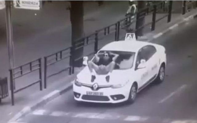 Security camera footage of a disturbed man interfering with traffic in Rishon Lezion, September 8, 2015. (Facebook) Security camera footage of a disturbed man interfering with traffic in Rishon Lezion, September 8, 2015. (Facebook)