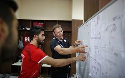 Italian Stefano Cusin, coach of the Palestinian Ahli Al-Khalil football club, discusses a play during the "Super Cup" match against al-Dahria at the Faisal al-Husseini Stadium in the West Bank town of Al-Ram, north of Jerusalem on September 11, 2015. (AP/Nasser Shiyoukhi)