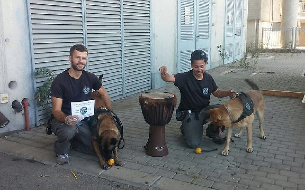 Customs investigators and a drug-sniffing dog pose next to the hashish-lined drum. (Courtesy Ben Gurion Customs) Customs investigators and a drug-sniffing dog pose next to the hashish-lined drum. (Courtesy Ben Gurion Customs)