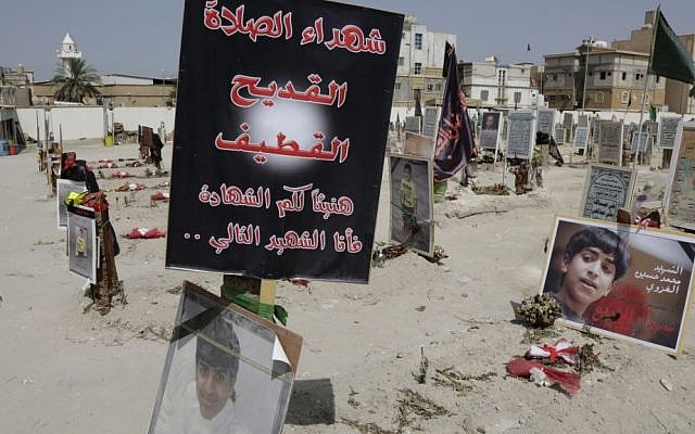 In this May 30, 2015 file photo, religious flags, photographs and tributes to 21 victims of a suicide bombing, claimed by the Islamic State group, of a Shiite mosque are seen attached to their graves at a cemetery in Qudeeh, Saudi Arabia. (AP/Hasan Jamali) In this May 30, 2015 file photo, religious flags, photographs and tributes to 21 victims of a suicide bombing, claimed by the Islamic State group, of a Shiite mosque are seen attached to their graves at a cemetery in Qudeeh, Saudi Arabia. (AP/Hasan Jamali)