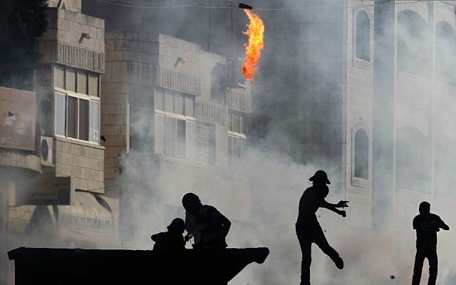 Illustrative: A Palestinian protester throws a firebomb during clashes with Israeli soldiers in the West Bank village of al-Ram, near Ramallah, on September 27, 2013. (Issam Rimawi/Flash90) Illustrative: A Palestinian protester throws a firebomb during clashes with Israeli soldiers in the West Bank village of al-Ram, near Ramallah, on September 27, 2013. (Issam Rimawi/Flash90)