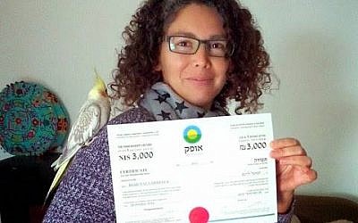 An Ofek member showing off her certificate (Photo credit: Facebook)