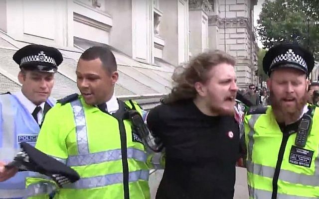 Metropolitan Police detain a pro-Palestinian demonstrator during protests outside Downing Street in London as Prime Minister Benjamin Netanyahu met with British counterpart David Cameron on September 9, 2015. (screen capture: YouTube) Metropolitan Police detain a pro-Palestinian demonstrator during protests outside Downing Street in London as Prime Minister Benjamin Netanyahu met with British counterpart David Cameron on September 9, 2015. (screen capture: YouTube)
