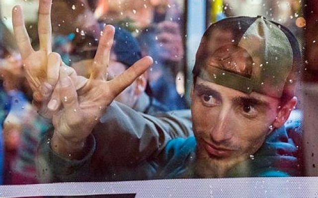 Refugees show the victory sign behind a bus window as they leave the train station in Saalfeld, central Germany, Saturday, September 5, 2015 (AP Photo/Jens Meyer) Refugees show the victory sign behind a bus window as they leave the train station in Saalfeld, central Germany, Saturday, September 5, 2015 (AP Photo/Jens Meyer)