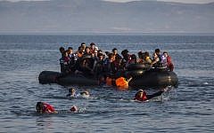 An illustrative image of migrants swimming from an overcrowded dinghy on July 27, 2015. (AP/Santi Palacios)