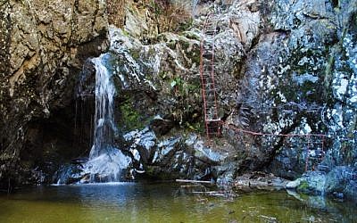 An image of the trail at Valea lui Stan, a narrow valley with huge cliffs and natural streams in Romania's Fagaras Mountains.