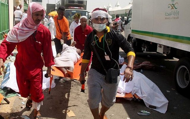 Saudi emergency personnel and Hajj pilgrims carry a wounded person at the site where hundreds were killed in a stampede in Mina, near the holy city of Mecca, at the annual hajj in Saudi Arabia on September 24, 2015. (AFP/ STR) Saudi emergency personnel and Hajj pilgrims carry a wounded person at the site where hundreds were killed in a stampede in Mina, near the holy city of Mecca, at the annual hajj in Saudi Arabia on September 24, 2015. (AFP/ STR)