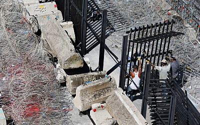 Lebanese workers set up tall metal barricades as an extra security measure around the Lebanese government building after the anti-government protesters remove the barbered wire barriers during the last demonstration, in downtown Beirut, Lebanon, Tuesday, September 1, 2015. (Hussein Malla/ AP)