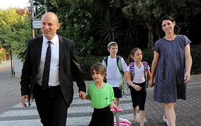 Education Minister Naftali Bennett walks his little girl Avigail to first grade, her first day of school and his first opening of a school year as the education minister, on Tuesday, September 1, 2015. (Sasson Tiram)