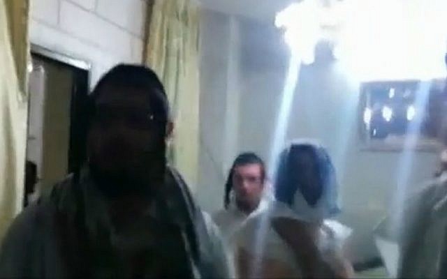 American yeshiva students inside the home of Palestinian Faiz Abu Hamadiah, who saved them from a mob in Hebron on September 3, 2015. (screen capture: Ynet)