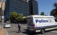 Police block off the scene near New South Wales Police Headquarters where a 15-year-old gunman shot dead a civilian police employee the previous day, before being gunned down by police, in Sydney on October 3, 2015. (AFP PHOTO/William WEST)