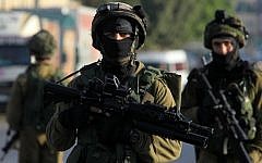 File. Israeli soldiers patrol a street, east of the West Bank city of Nablus, on October 3, 2015, as they search for the suspected Palestinian killers of Israeli couple Eitam and Naama Henkin. (AFP PHOTO/JAAFAR ASHTIYEH)