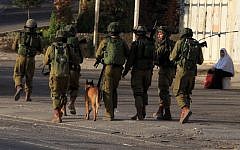 Israeli soldiers patrol a street, east of the West Bank city of Nablus, on October 3, 2015, as they search for the suspects in the slaying of an Israeli couple. (AFP/ JAAFAR ASHTIYEH)