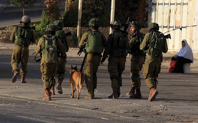 Israeli soldiers patrol a street, east of the West Bank city of Nablus, on October 3, 2015, as they search for the suspects in the slaying of an Israeli couple. (AFP/ JAAFAR ASHTIYEH) Israeli soldiers patrol a street, east of the West Bank city of Nablus, on October 3, 2015, as they search for the suspects in the slaying of an Israeli couple. (AFP/ JAAFAR ASHTIYEH)