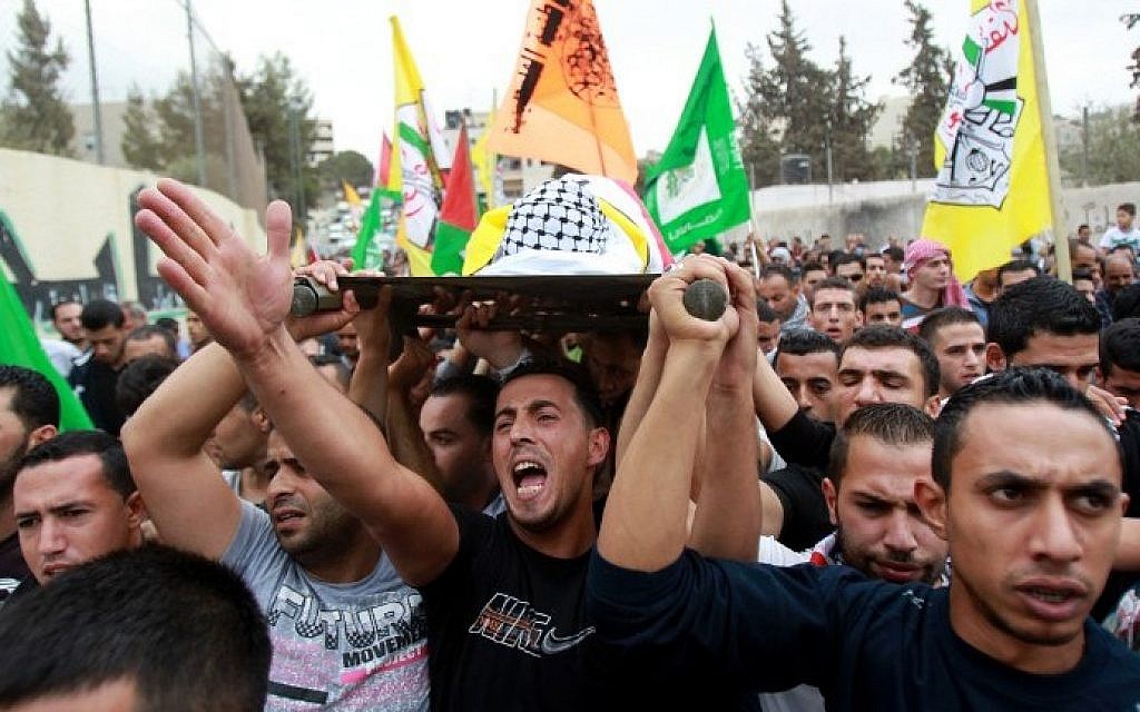 Mourners carry the body of 13-year-old Palestinian Abdel Rahman Abdullah, who was shot dead by the Israeli army during clashes at a refugee camp near Bethlehem, during his funeral at the Aida refugee camp near the West Bank town of Bethlehem on October 6, 2015. (AFP/Musa al-Shaer)