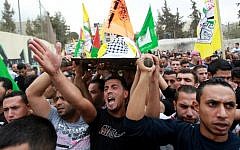Mourners carry the body of 13-year-old Palestinian Abdel Rahman Abdullah, who was shot dead by the Israeli army during clashes at a refugee camp near Bethlehem, during his funeral at the Aida refugee camp near the West Bank town of Bethlehem on October 6, 2015. (AFP/Musa al-Shaer)